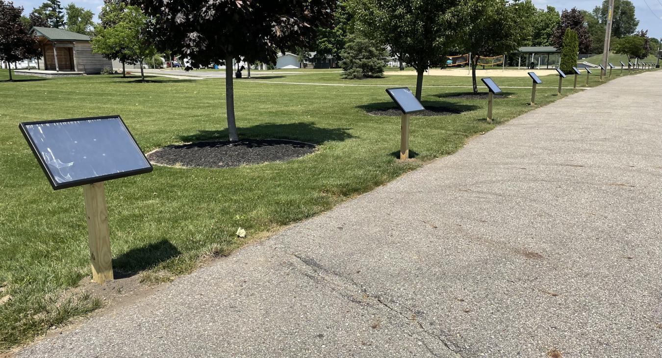 long view of several StoryWalk® Signs at Quincy Park
